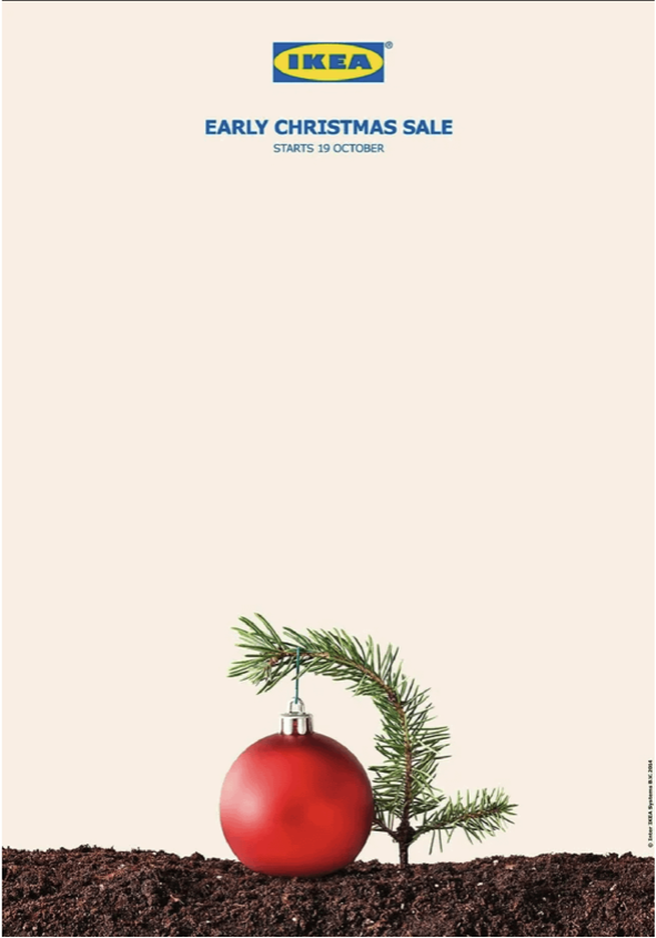 A small pine branch bends over a red ornament in soil to resemble a Christmas tree sapling; text reads ‘IKEA Early Christmas Sale starts 16 October.’