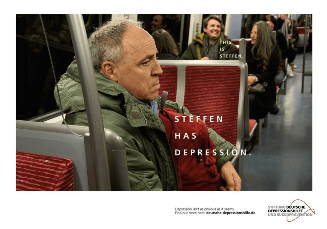 A sad man sits alone on a subway next to large text, ‘Steffen has depression,’; smaller text then identifies a different smiling passenger as Steffen, showing depression isn’t always visible.