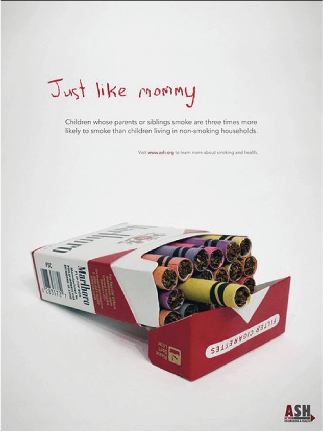 A cigarette pack filled with crayons sits open; above it, childlike text reads ‘Just like mommy,’ linking smoking to children copying adult behavior.